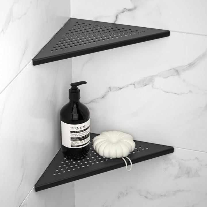 two black shelves with soap, lotion and garlic on them in a white tiled bathroom