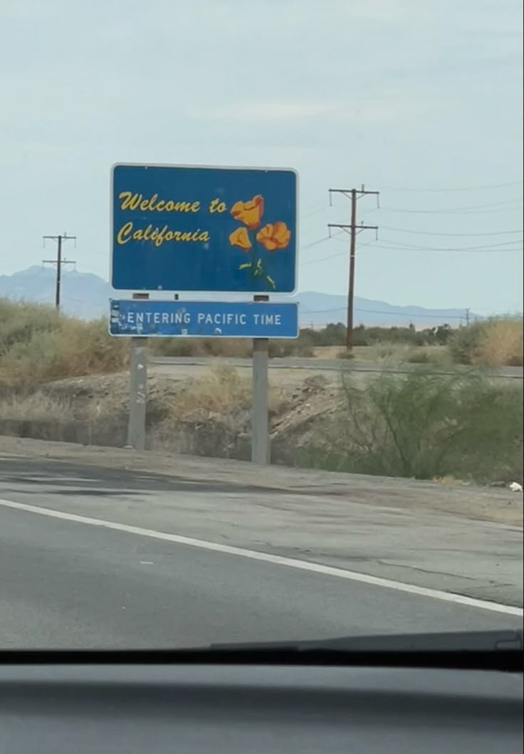 a welcome to california sign on the side of the road