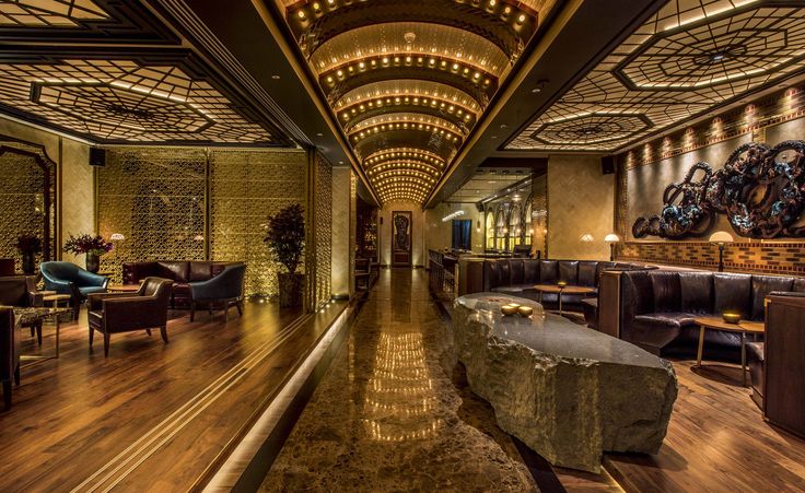 an elegant lobby with wooden floors and walls