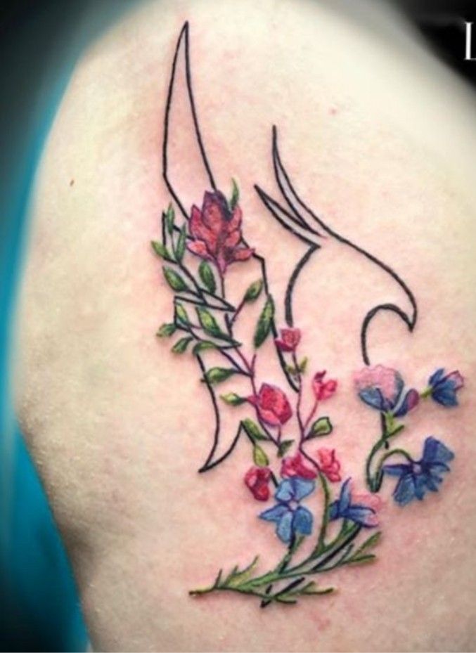 a woman's back shoulder with flowers and vines on the upper part of her arm