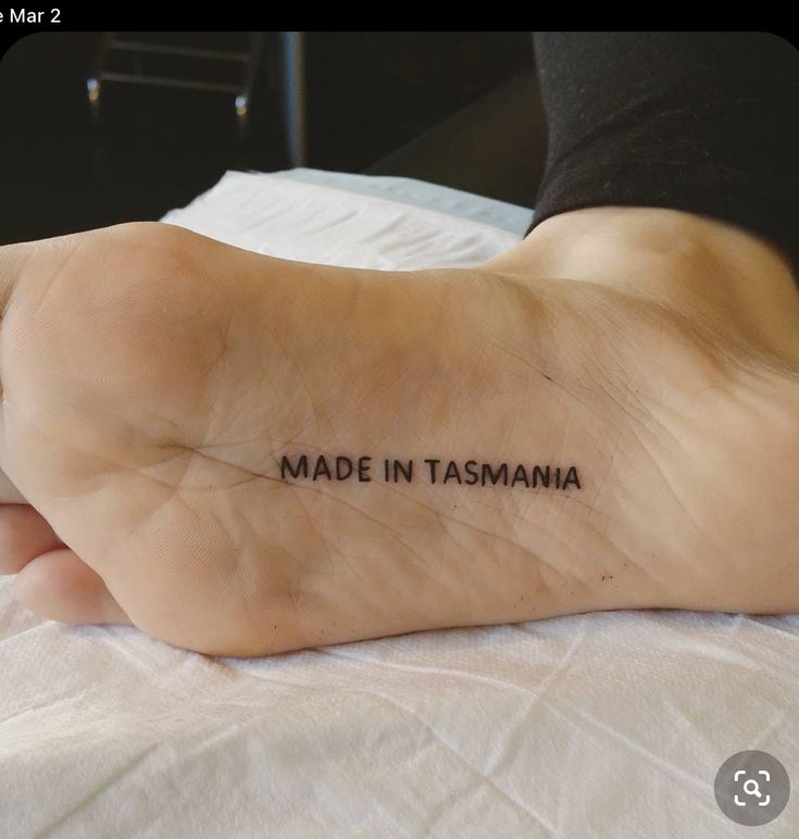 a woman's foot with the words made in tasmania written on it