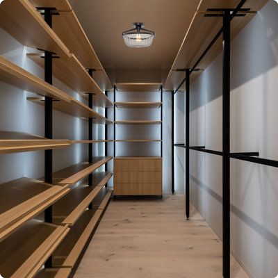 an empty walk in closet with shelves and lights