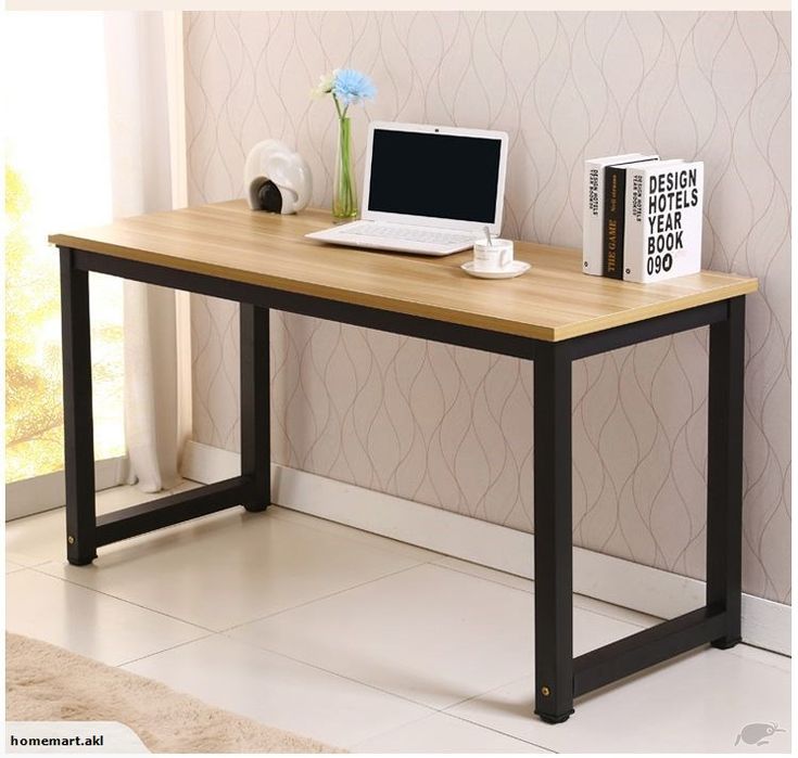 a laptop computer sitting on top of a wooden desk next to a bookshelf