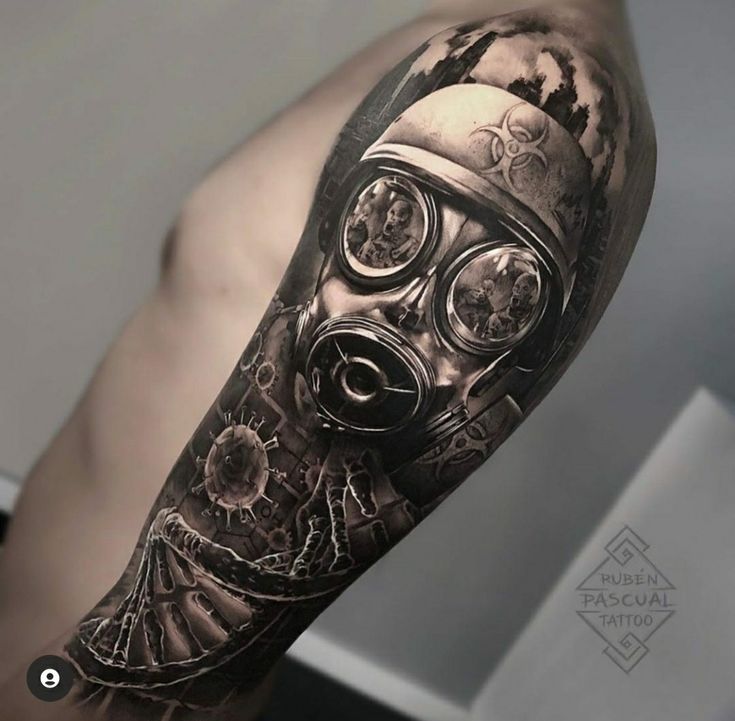 a man with a gas mask tattoo on his arm