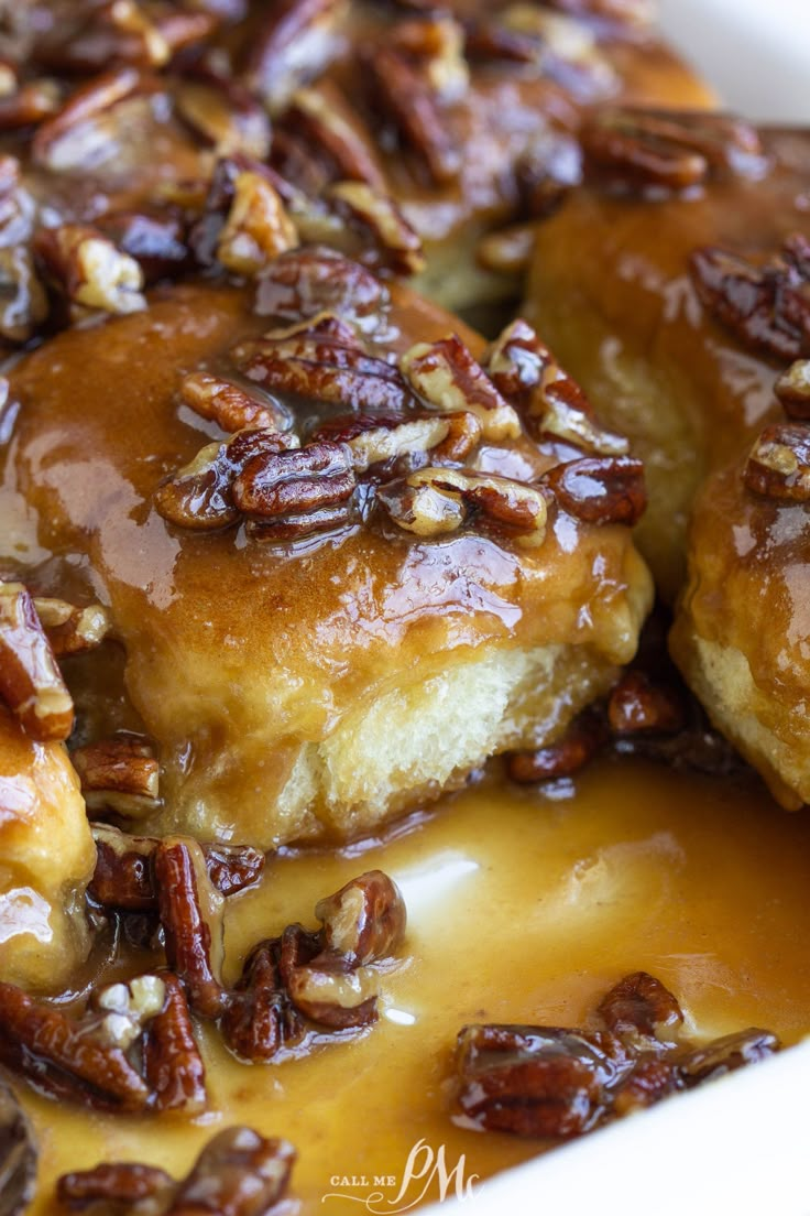 pecans and caramel sauce are on top of sticky rolls