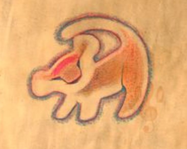 a drawing of a lion on the side of a piece of paper that is drawn with colored pencils