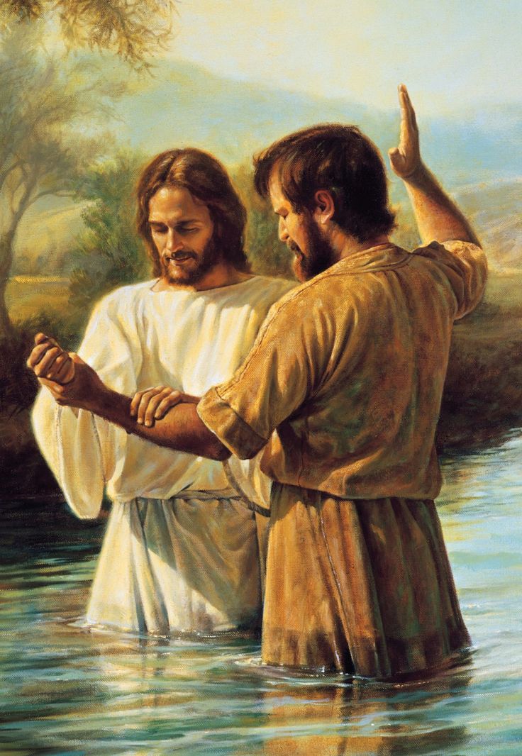 two men are standing in the water with their hands together and one man is holding his hand out