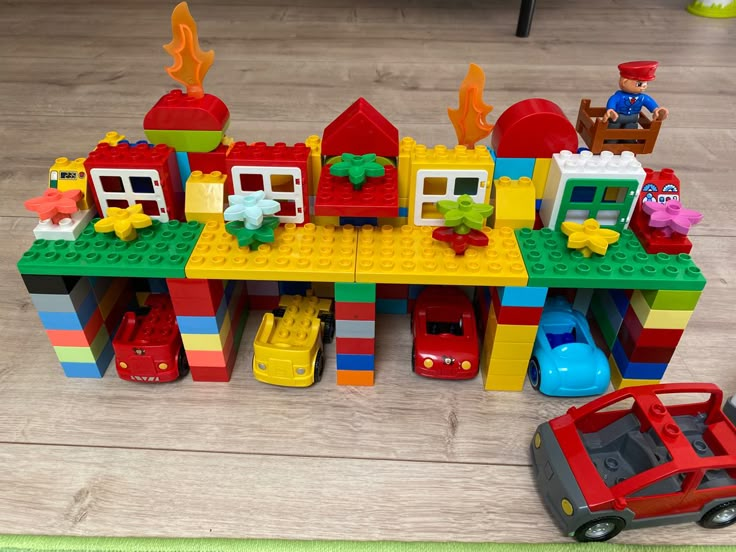 a toy house made out of legos on the floor