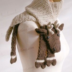 a white mannequin wearing a knitted scarf with two brown horses on it