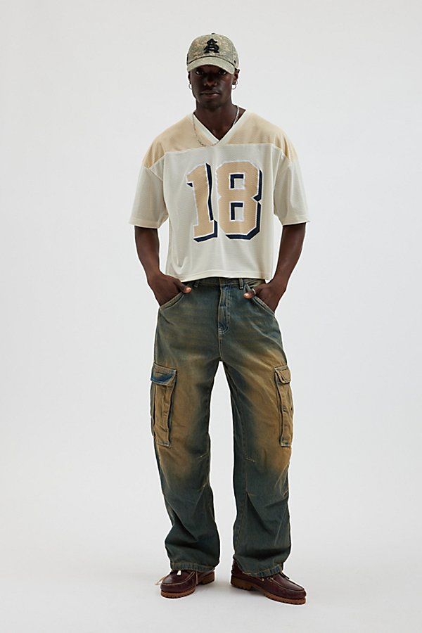 Mesh football jersey by Urban Outfitters. Semi sheer short sleeve t-shirt with a number graphic at the front. Boxy fit tee in a cropped length. Features UO football jersey Mesh football jersey tee Two-tone V-neck Number graphic Short sleeve Cropped length Content + Care 100% Polyester Machine wash Imported Size + Fit Model in Neutral is 6’2.5" and wearing size Medium Measurements taken from size Medium Chest: 46" Length: 23.5" | Urban Outfitters UO Mesh Football Jersey Tee in Neutral, Men's at U Mens Fashion Tshirts Style, Mens Fashion California, Custom Football Shirts For Boyfriend, Mens Streetwear Shirts, Cream T Shirt Outfit Men, 90s Outfits For Men, Mesh Jersey Outfit Men, Boxy Tee Outfit Men, Football Season Short Sleeve Streetwear T-shirt