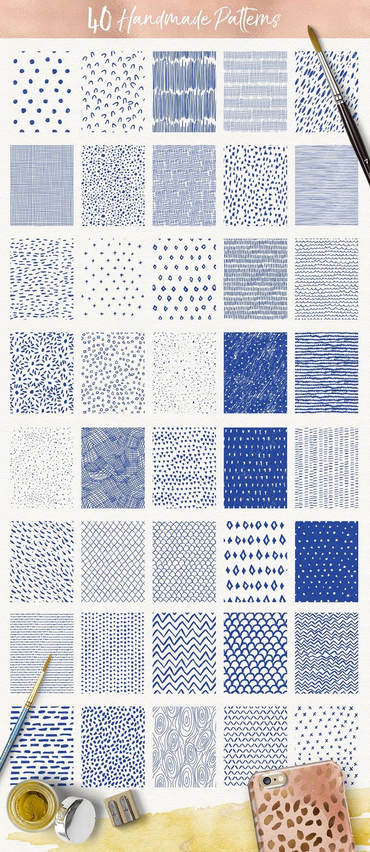 blue and white hand drawn patterns with paintbrushes on the table next to them