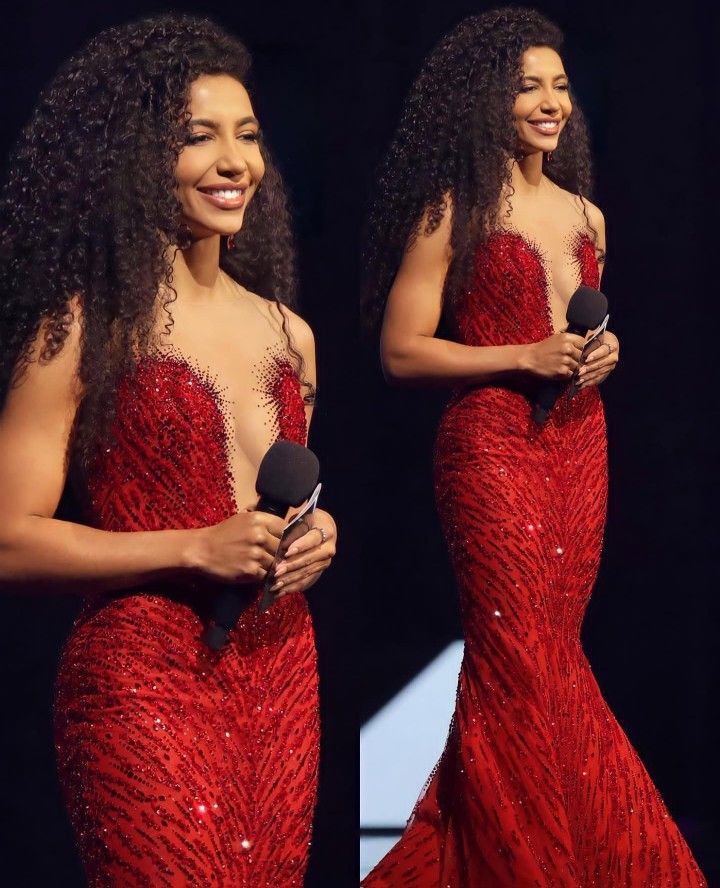 a woman in a red dress holding a microphone