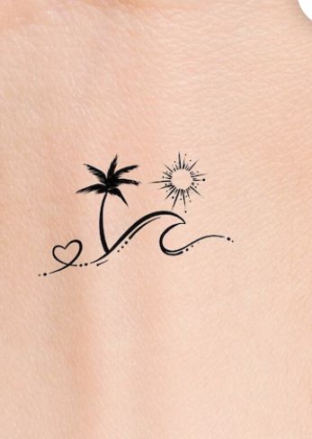 the back of a woman's shoulder with a small tattoo design on her left side