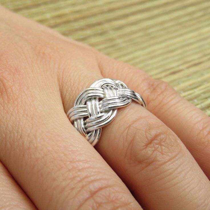 This braided silver ring is a perfect wedding band. This is a wide band ring and its surface is woven out of silver like a flat braid with three threads. This ring has a deep symbolic meaning: each strand holds the others, hugging them and creating the endless flow. This ring was first created in wax then cast in sterling silver. Each band is individually braided to get the right size. The ring will be made to order, so please choose the correct size. If you know your size in British scale - wri Braided Wedding Rings, Silver Wire Jewelry, Man Wedding, Silver Wedding Ring, Copper Jewellery, Silver Wedding Band, Woven Ring, Sterling Silver Wedding Band, Wide Band Ring