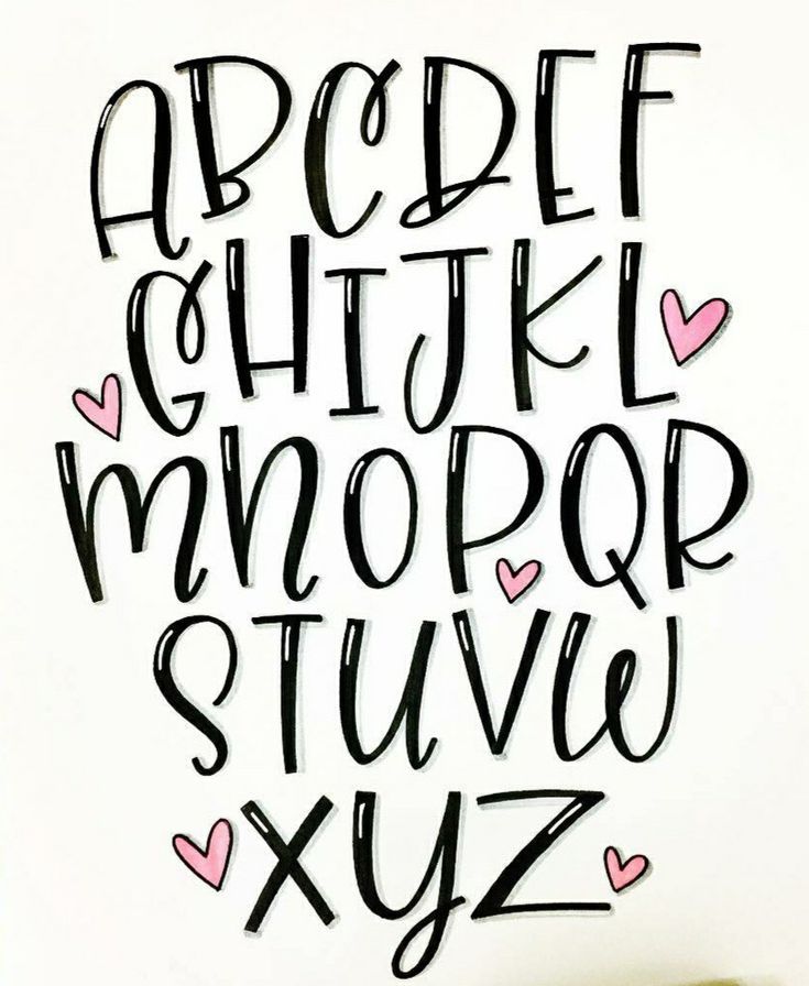 a handwritten alphabet with hearts on it and the letters are black, white, and pink