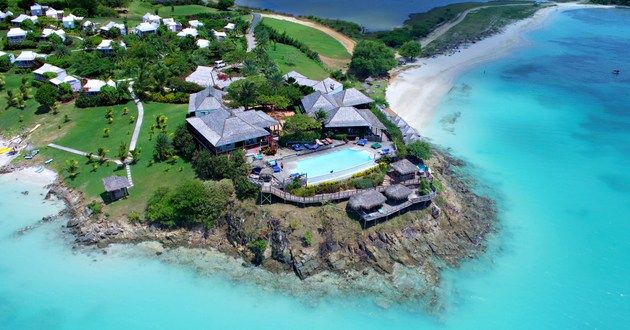 an aerial view of the resort and its surrounding grounds, including a swimming pool in the foreground