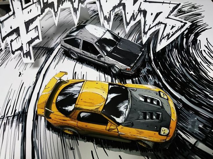 two cars are parked in front of graffiti on the side of a building, one is yellow and black