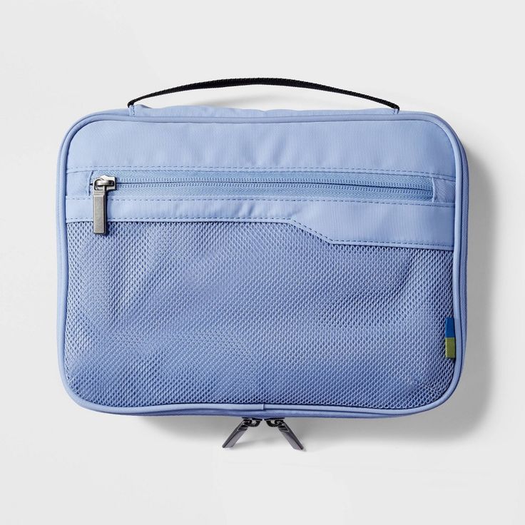 an empty blue bag on a white surface with a zippered pocket in the middle