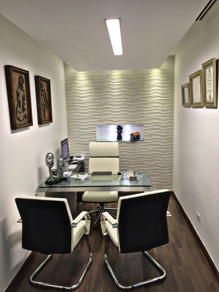 an office with white walls and black chairs