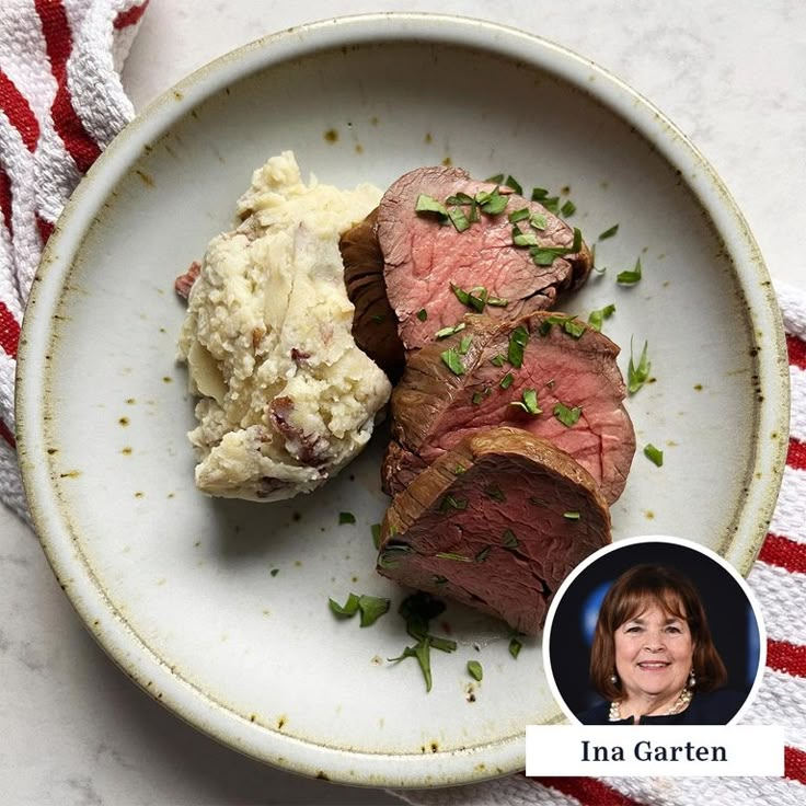 a white plate topped with steak and mashed potatoes next to a woman's face