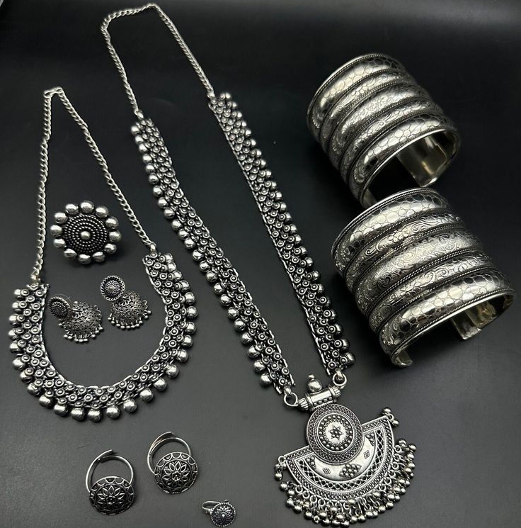 Luxury Oxidized Finish Temple Necklace For Festivals, Luxury Oxidized Temple Jewelry, Adjustable Silver Jewelry With Motifs, Traditional Jewelry Sets With Latkans, Navratri Themed Motif Jewelry Gift, Traditional Silver Sets As Gift, Traditional Silver Sets For Gifts, Traditional Silver Sets For Navratri, Bohemian Jewelry Sets With Intricate Design