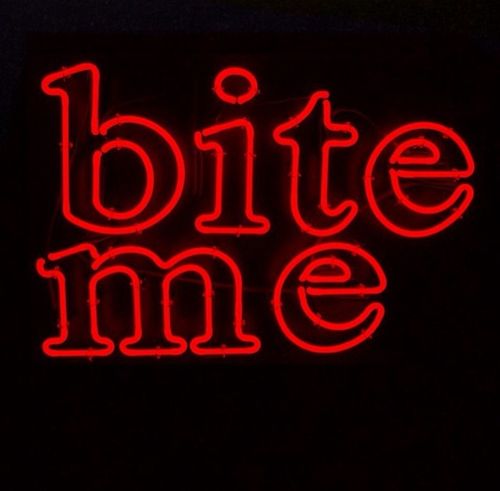 the words bite me are lit up in red