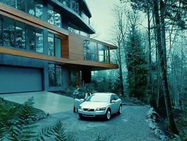 a car parked in front of a large house