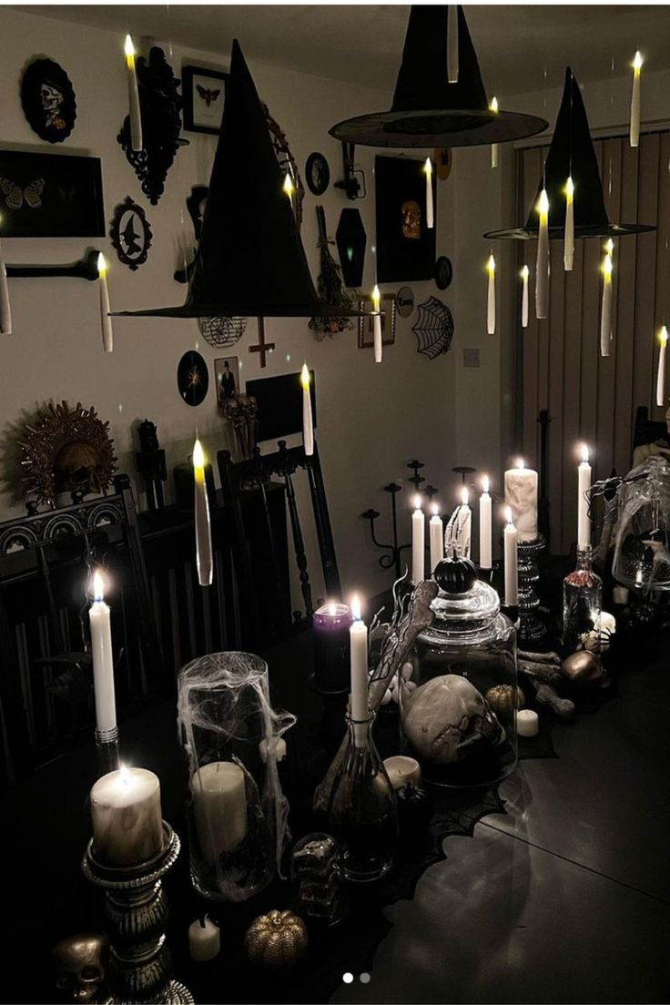 a table topped with lots of candles and skulls