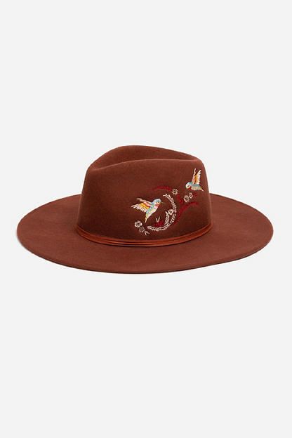 Crafted from 100% wool, the Hummingbird Heather Hat is available in an earthy rust color. Featuring a mid-height crown and a wide brim, this hat is finished with intricate placement embroidery and a decorative feather placed thoughtfully at the hatband. Style with a denim-on-denim look and western style boots for an eclectic ensemble. Johnny Was Women's Hummingbird Feather Hat in Rust Brown, Denim Brown Fedora For Rodeo In Fall, Brown Felt Hat For Fall Rodeo, Brown Felt Hat For Rodeo In Fall, Brown Felt Hat With Flat Crown For Fall, Fall Rodeo Brown Felt Hat, Brown Flat Crown Felt Hat For Spring, Spring Brown Wool Felt Hat, Spring Brown Wool Hat, Bohemian Wool Felt Hat For Fall