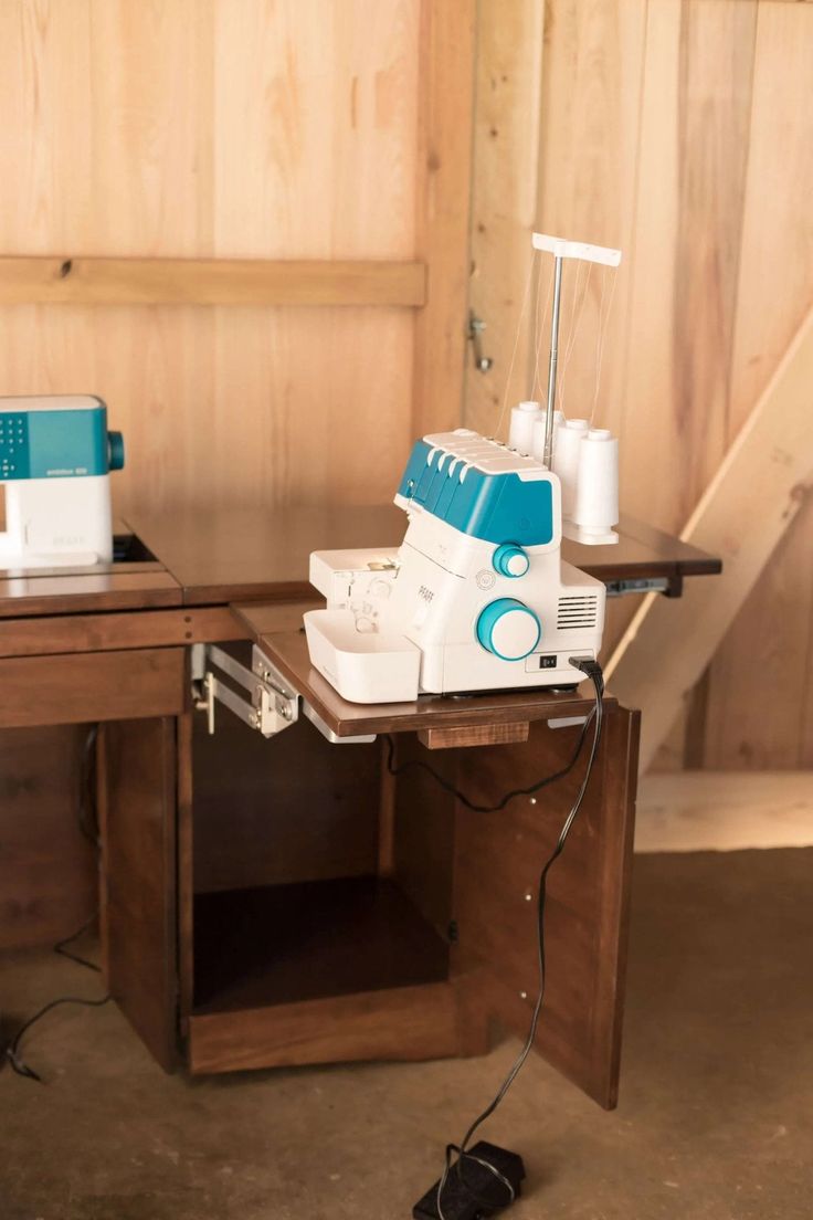 a sewing machine sitting on top of a wooden table