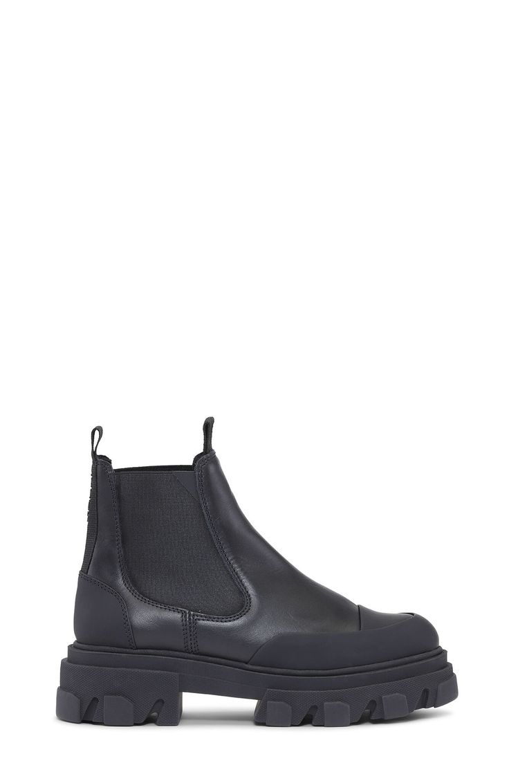 Signature GANNI low leather chelsea boots with super chunky, ribbed rubber soles, elasticated and toe caps. <br><br><ul> <li>Hit low just at ankle </li> <li>Runs small to size, take a size up for a more comfortable fit.</li> <li>Pronounced rubber welts</li> <li>Round toe</li> <li>Subtle GANNI logo at back ankle</li> <li>Front and back pull tabs</li> <li>Slip on chelsea-style with elastic panels</li> <li>100% leather upper with rubber soles</li> <li>Made in Portugal</li> </ul> Floral Bags, Super Chunky, Leather Chelsea Boots, Crossbody Tote, Chelsea Boot, Small Gifts, Chelsea Boots, Chelsea, Leather Upper