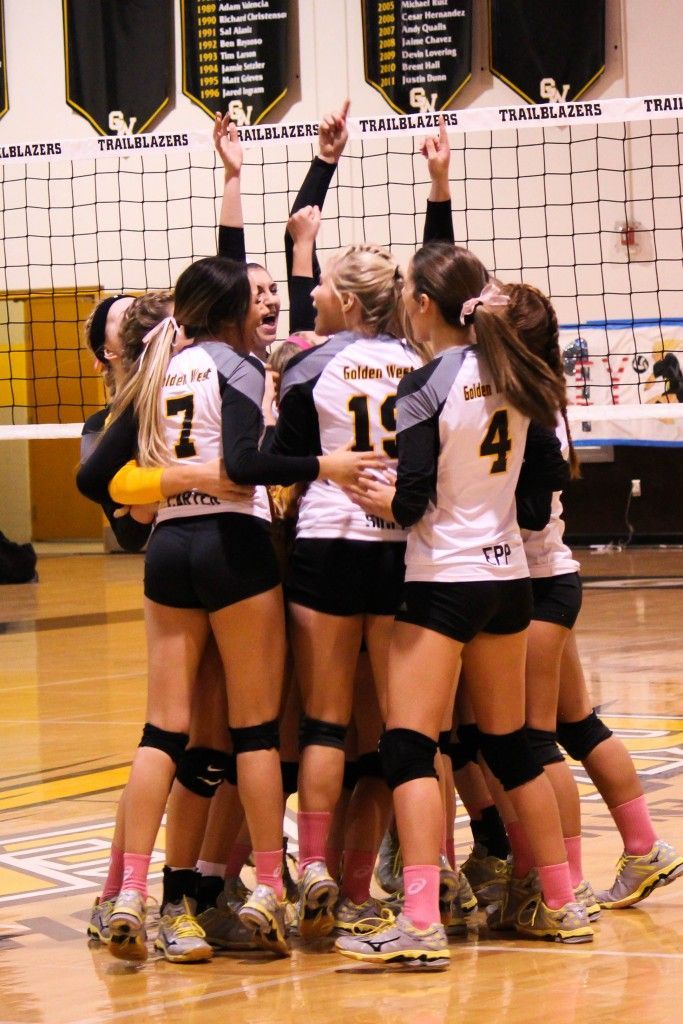 the volleyball team is huddled together in a huddle