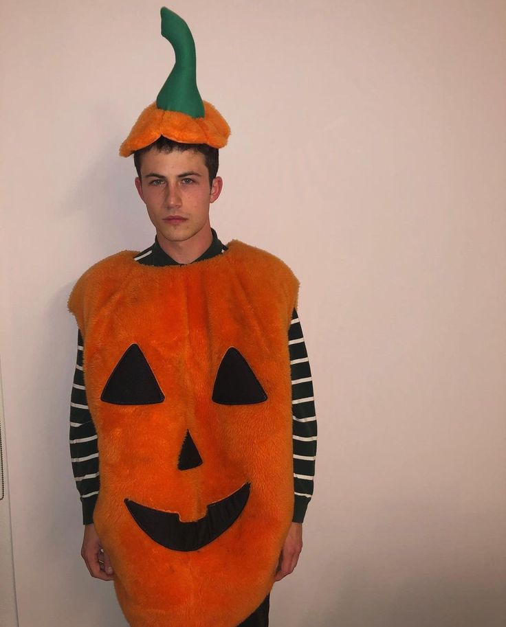 a young man dressed up as a pumpkin