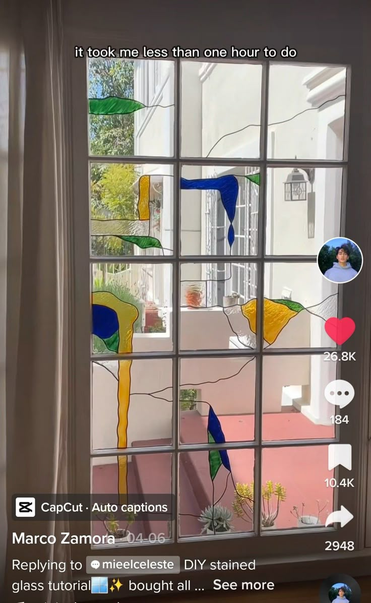 an image of a window that has been decorated with different colors and shapes on it