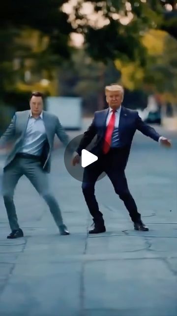 two men in suits and ties are playing with a frisbee