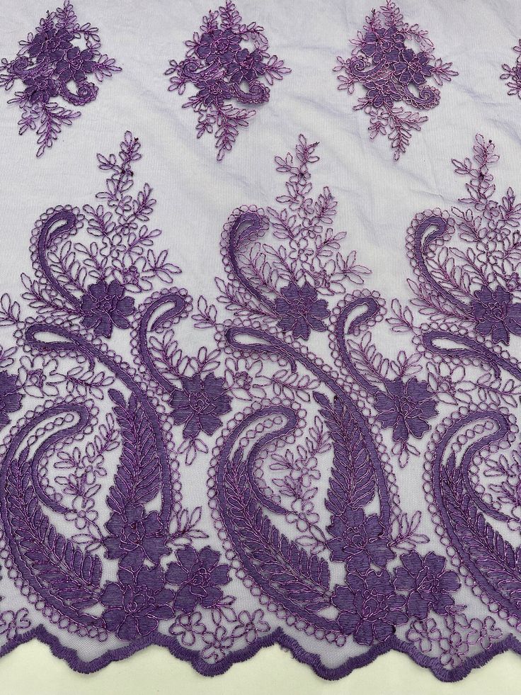 purple lace on white fabric with floral design