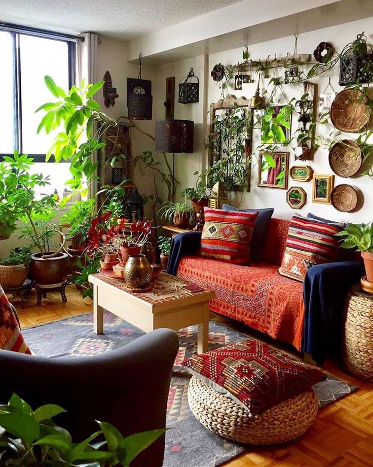 a living room filled with furniture and lots of plants