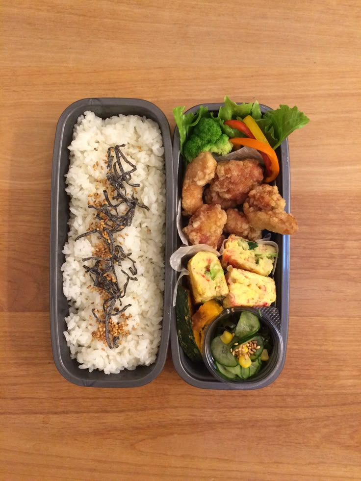 two plastic containers filled with food on top of a wooden table