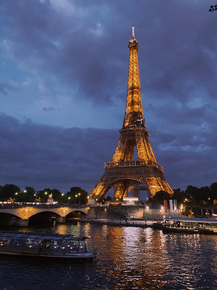 Eiffel Tower lit up with cloudy evening background. Aesthetic Pictures Of Paris, Paris Story, Paris Night Wallpaper Iphone, Paris Scenery Aesthetic, Paris Vibes Night, Paris At Night Wallpaper, Real Life Disney Characters, Paris Eiffel Tower Aesthetic Night, Beautiful Scenery Photography