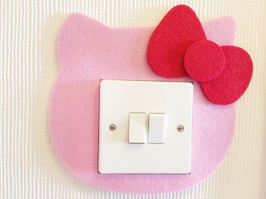 a hello kitty light switch cover with two hearts on it