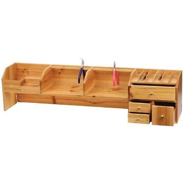 a wooden bench with drawers and scissors on it's sides, in front of a white background