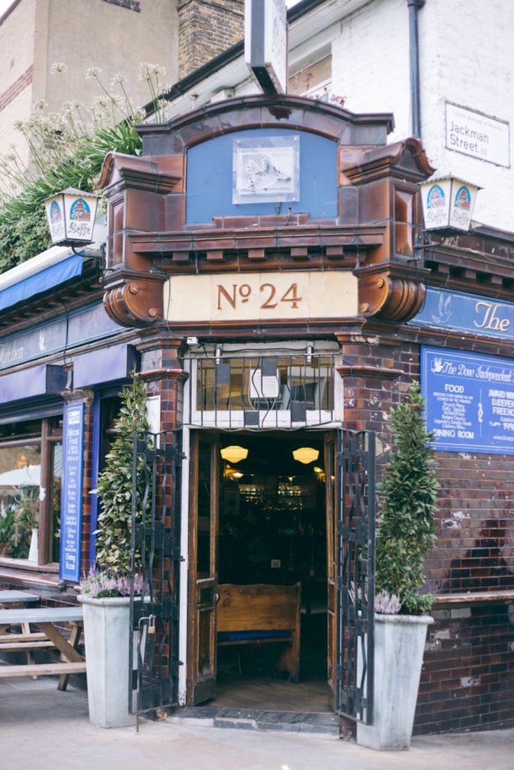 an old building with plants growing out of it's front door and number 944 on the outside