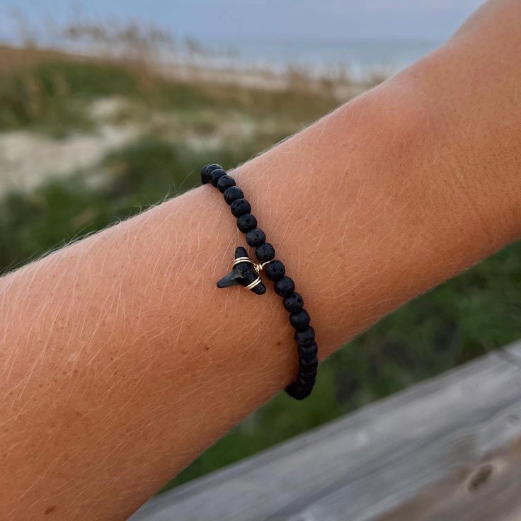 shark tooth beaded bracelet 🦈  each tooth will be different, but similar in size to the photo above! hand wrapped shark teeth found in NC * made to a standard size to fit most, please reach out to me for sizing concerns! Made on stretchy string. Shark Tooth Bracelet, Tooth Bracelet, Ocean Isle Beach Nc, Bracelet Ocean, Beachy Bracelets, Ocean Isle Beach, Lover Jewelry, Surfer Bracelets, Shark Tooth