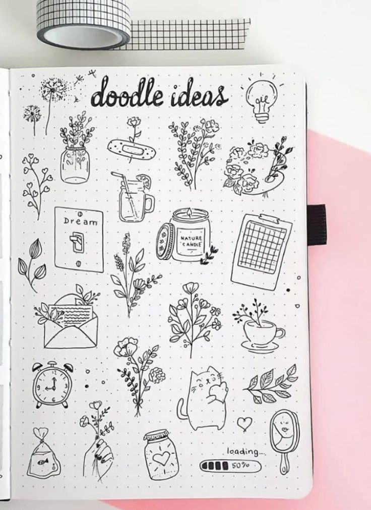 an open notebook with doodles on it and various things in the pages next to it