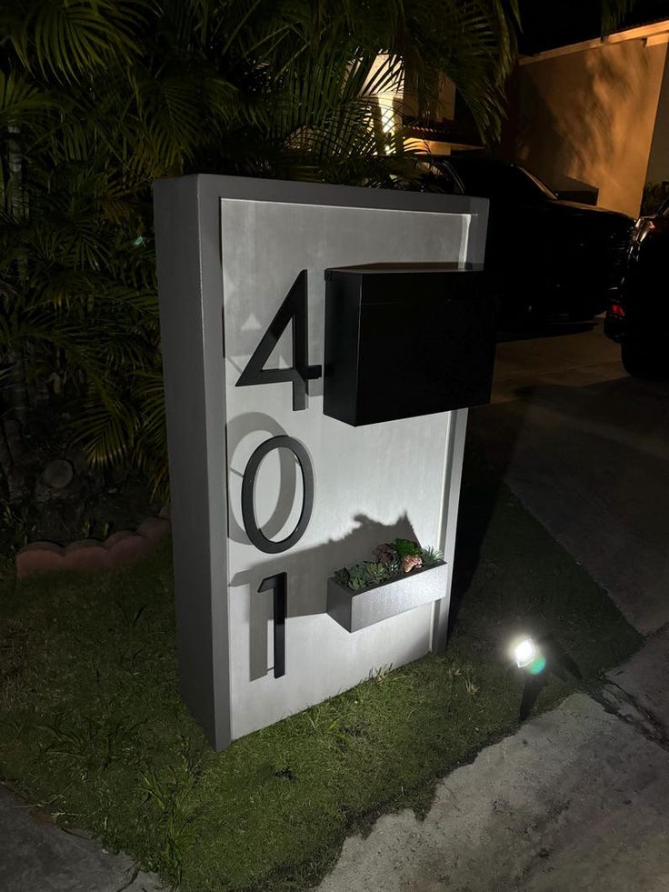 a sign that is on the side of a road with grass in front of it