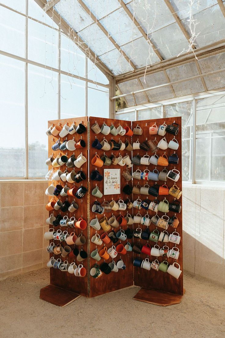 there are many pairs of shoes on display in the room with glass walls and floor to ceiling windows