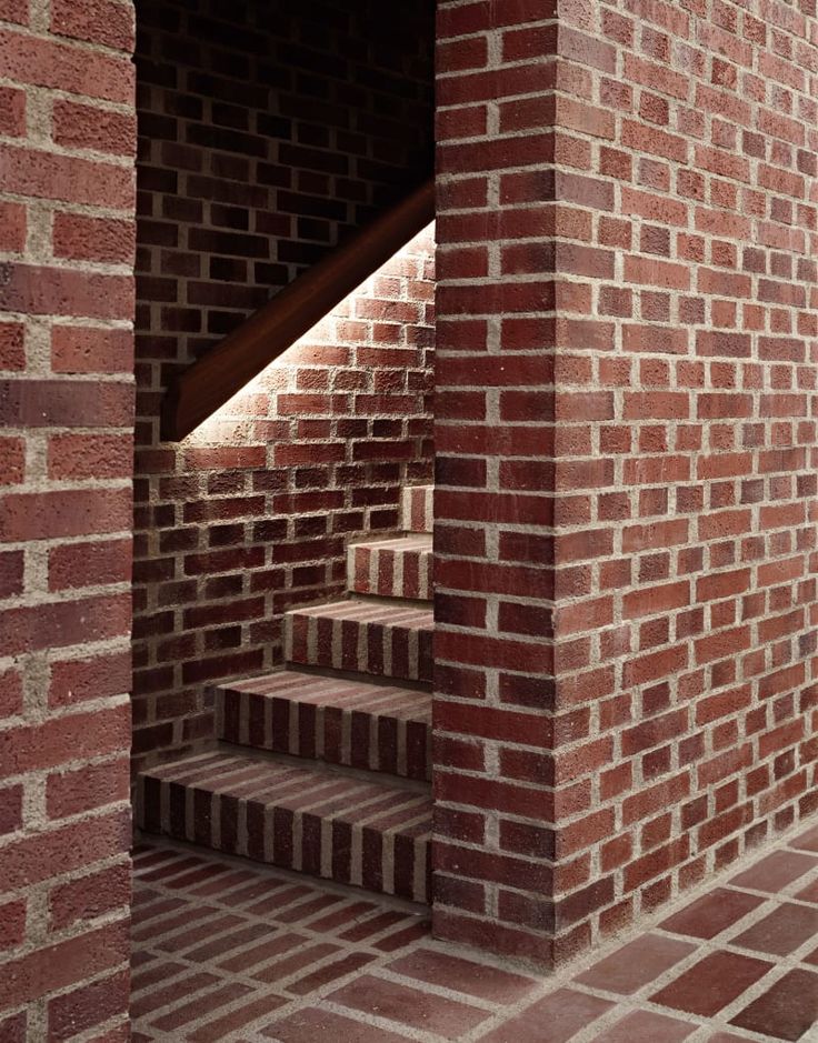 an open brick wall with steps leading up to the second floor and another set of stairs