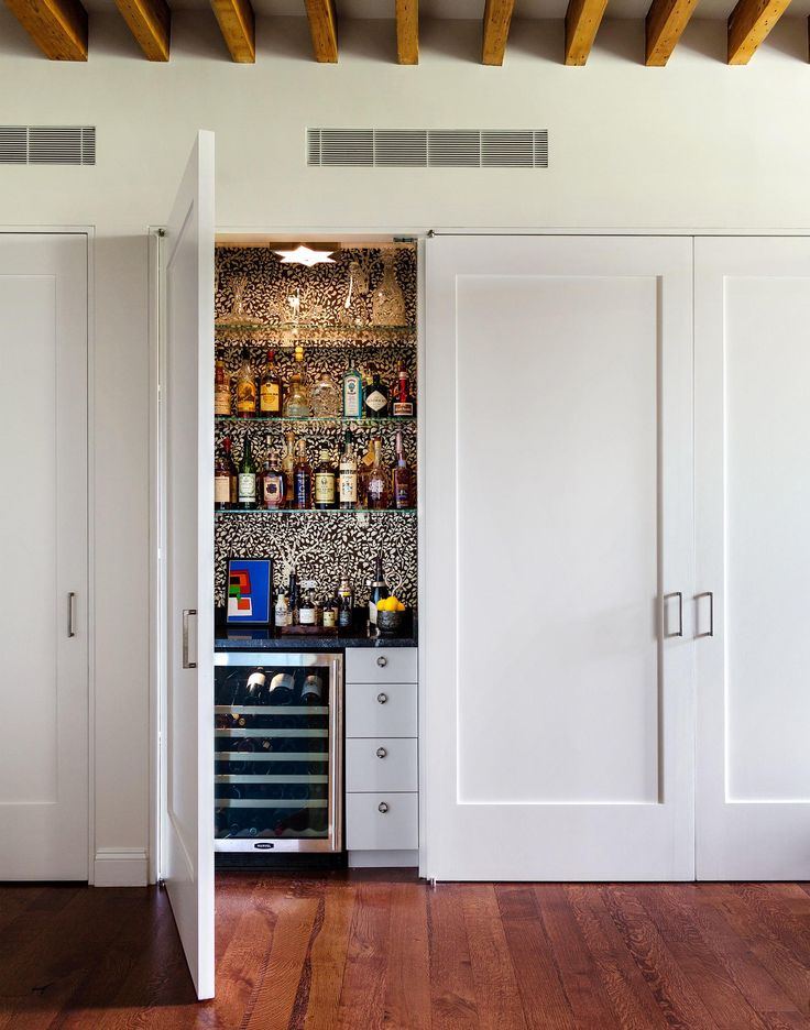 a room with white closets and wooden floors