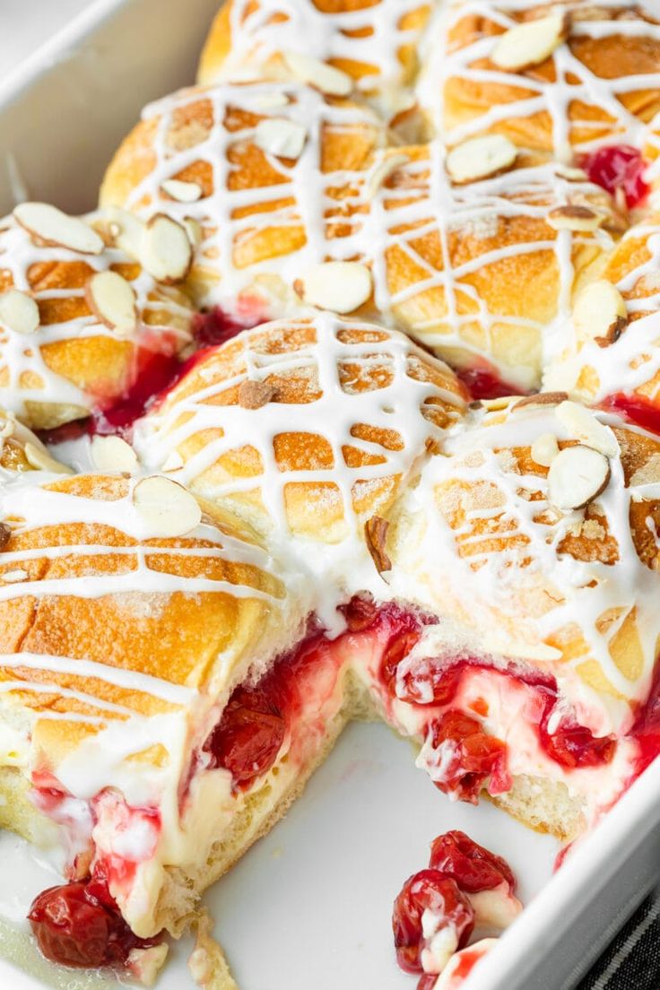 a close up of a cake in a pan with white icing on the top