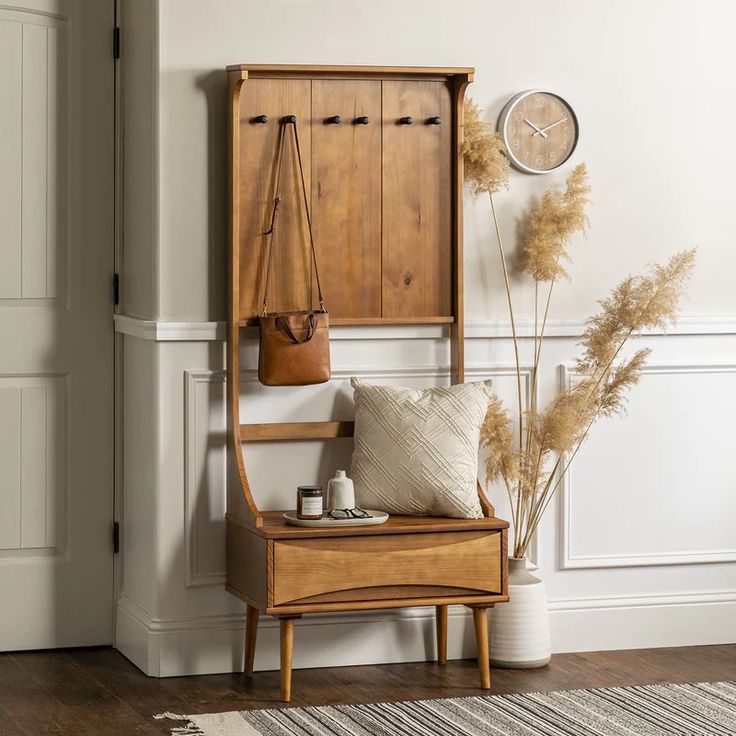 a wooden bench sitting next to a clock on the wall